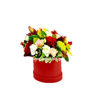Colorful flower arrangement in red round box